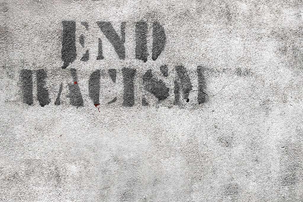 Graffiti reading "End Racism."